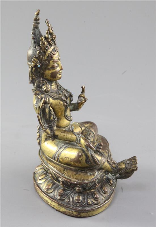 A Tibetan gilt copper alloy seated figure of Green Tara, 17th / 18th century, height 16.5cm